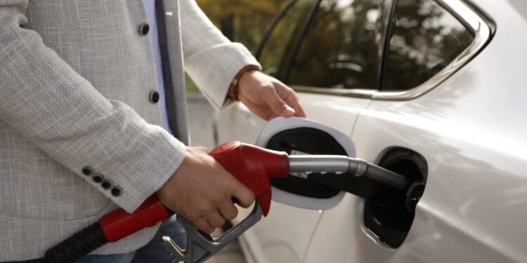 Man refueling car at self service gas station, closeup