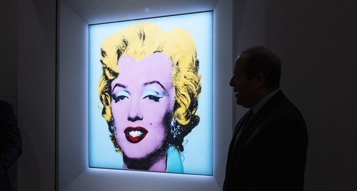 epa09840755 Marc Porter, Chairman of Christie's Americas, standing in front of the 1964 painting 'Shot Sage Blue Marilyn' by Andy Warhol during a press conference announcing the upcoming auction of the painting at Christie's in New York, New York, USA, 21 March 2022. The painting, which is being sold by the Thomas and Doris Ammann Foundation Zurich during an auction in May, is expected to sell for nearly 200 million USD / 181 million euro and proceeds with all go to the foundation's charitable works. EPA/JUSTIN LANE